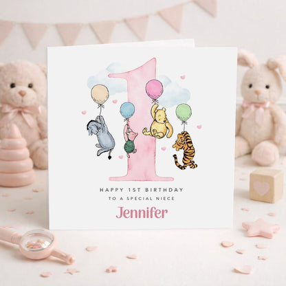 A personalized birthday card for a baby girl named Jennifer, featuring illustrations of Winnie the Pooh and other characters, along with balloons and a pink number one.
