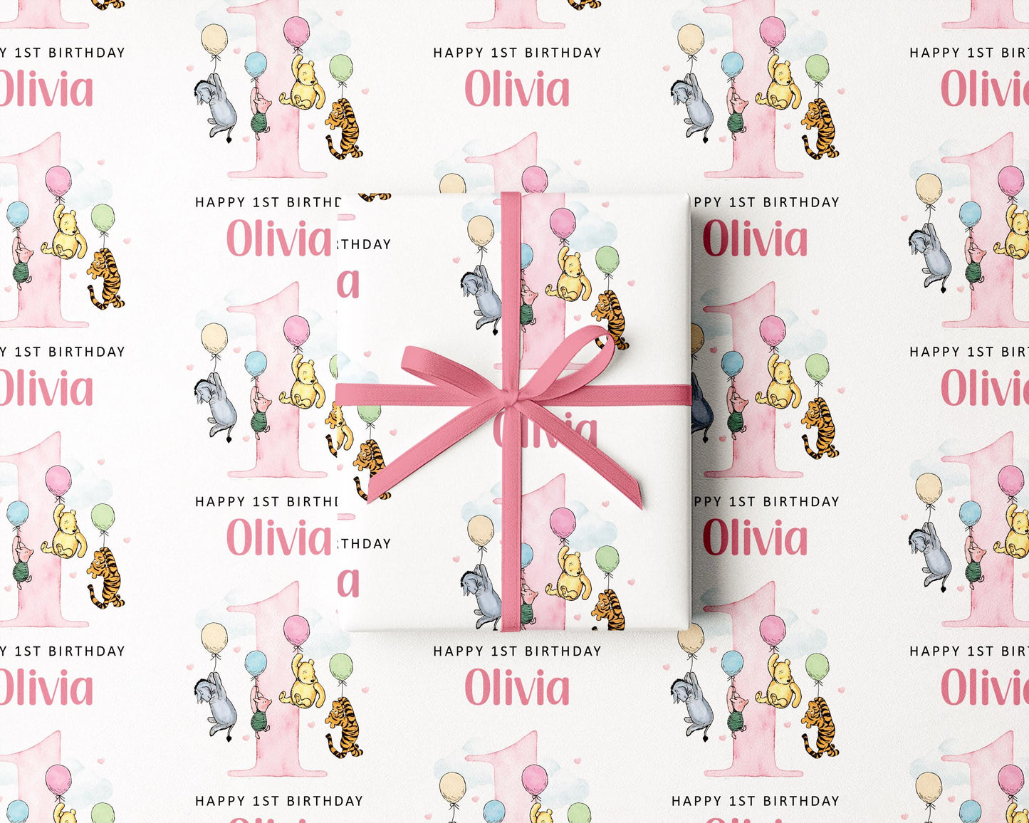 The image is a repeating pattern of a pink gift box with a bow, featuring illustrations of Winnie the Pooh and other characters, along with the text "Happy 1st Birthday Olivia" and "Happy 1st Birthday" written on it.
