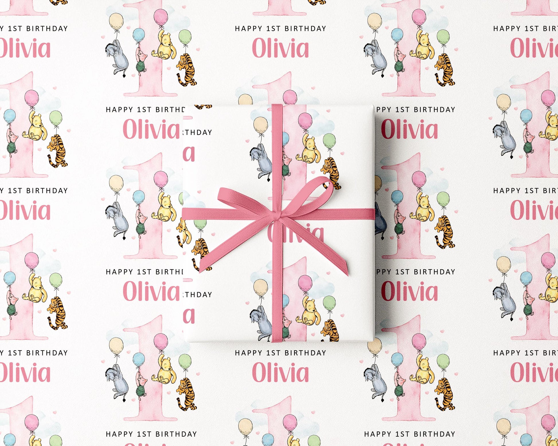 The image is a repeating pattern of a pink gift box with a bow, featuring illustrations of Winnie the Pooh and other characters, along with the text "Happy 1st Birthday Olivia" and "Happy 1st Birthday" written on it.